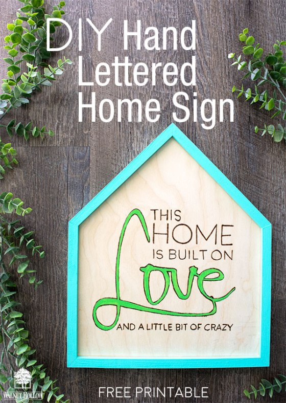This home is built on Love and a little bit of Crazy hand lettered wood burned sign